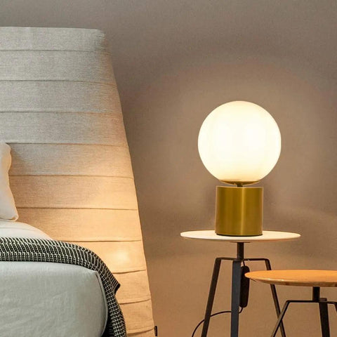 11 Inch Modern Gold Globe Table Lamp With Milk White Glass Shade and Sturdy Metal Base on bedside table in bedroom