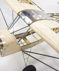 Close-up of Savage Bobber Balsa Wood RC Airplane Kit With 1000mm Wingspan showing laser-cut parts and cockpit frame.