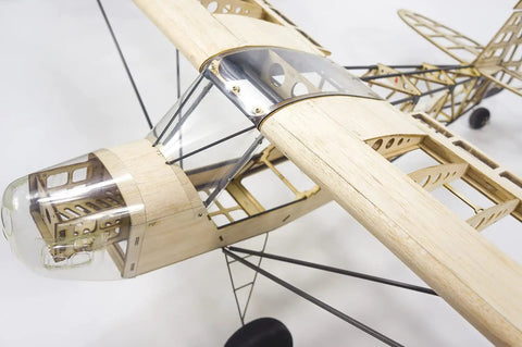 Close-up of Savage Bobber Balsa Wood RC Airplane Kit With 1000mm Wingspan showing laser-cut parts and cockpit frame.