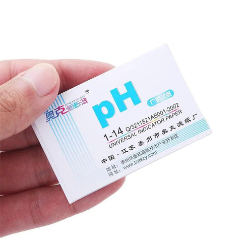 Hand holding 80 Strips Pack PH Tester Strips Full Range 1 to 14 Litmus Paper with label visible for home chemistry projects