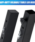 Heavy Duty Four Pack Square Table Leg Extenders Providing Three Adjustable Height Settings From Two To Six Inches For Easy Tool Free Folding Table Mods. Two black metal risers displayed.