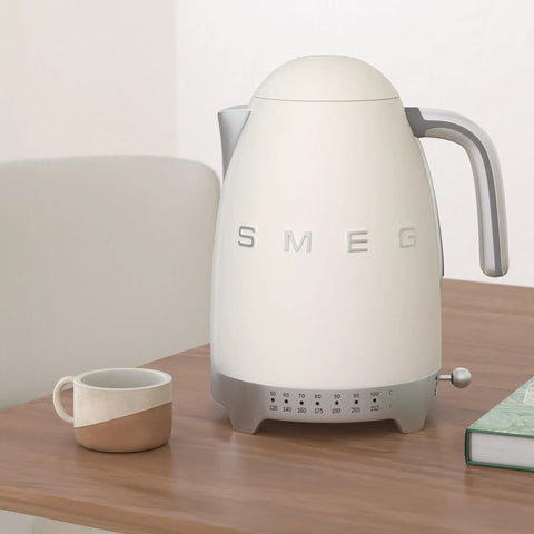 Variable Temperature Electric Kettle 1.7L With Fast Boil 1400W For Tea Or Coffee Nerds 122F To 212F Adjustable Temperature Keeps Warm Auto Shut Off 360 Degree Swivel Base Retro Cream Finish on wooden table next to ceramic mug.