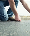Person using Pro Grade Chalk Line Reel With 110 Foot Reach, 12 Ounce Chalk Capacity on road surface for straight line layout