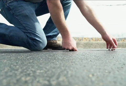 Person using Pro Grade Chalk Line Reel With 110 Foot Reach, 12 Ounce Chalk Capacity on road surface for straight line layout