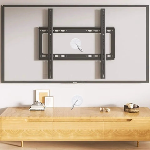 Hide Messy TV Cables Behind The Wall With This In Wall Cable Management Kit 4 Pass Throughs 1 Hole Saw Drill Attachment Two And Three Eighths Inch Hole Easy To Install For Wall Mounted Televisions Durable In Wall Wire Hider installation setup on wall with TV bracket.