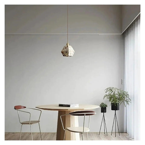 Industrial Marble Pendant Light Fixture Chandeliers in a modern dining area with wooden table and plants.