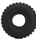 Knobby black off-road tire with deep tread, perfect for traction on rugged terrains.