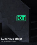 Two Pack Glow In The Dark Aluminum Exit Signs 12x7 Inches Photoluminescent Laminated For UV Weather And Fade Resistance Built Tough Easy To Spot Indoors And Outdoors For Office School Warehouse Business Fire Exit Sign glowing green EXIT sign on a dark wall