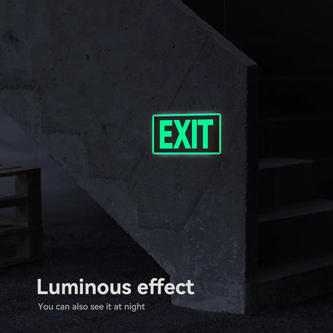 Two Pack Glow In The Dark Aluminum Exit Signs 12x7 Inches Photoluminescent Laminated For UV Weather And Fade Resistance Built Tough Easy To Spot Indoors And Outdoors For Office School Warehouse Business Fire Exit Sign glowing green EXIT sign on a dark wall