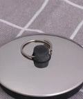 Close-up of 2pcs Rubber Bathtub Drain Stopper for Kitchen and Laundry Use, featuring a flat rubber design with a metal pull ring.