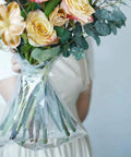 Clear Flower Water Bags Pro Grade 100 Pack Transparent Wrapping Sleeves For Bouquets displaying fresh bouquet stems in use.