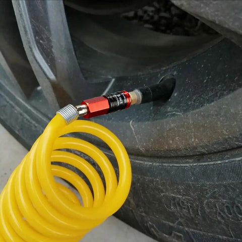 Heavy Duty 5 In 1 Universal Quick Industrial Air Coupler With Dead Simple Setup And Knockout Durability For 1/4 Inch Female Npt Air Compressor Fittings Quick Connect Accessory In Bold Red attached to a yellow coil hose for tire inflation.