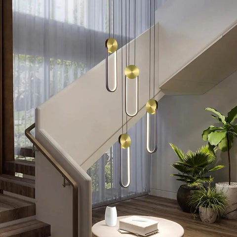 Black And Gold LED Pendant Light With Minimalist Oval Design 10W Warm White Single Hanging Fixture For Bedroom, Living Room, Bathroom, And Restaurants, Modern Sleek Vibe Ceiling Light hanging in a staircase area