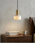 HLRCB Indoor Pendant Light, Marble Adjustable Drop, Modern Suspended Mount over a bedside table with books and a mug.