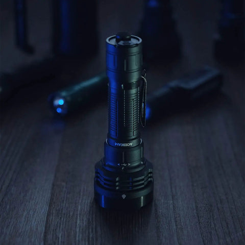 Defender P18 Tactical Flashlight with Dual Tail Switch 5000 Lumen LED rechargeable on wooden table with other flashlights.