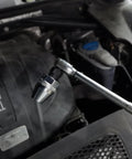 Damaged Bolt And Stud Extractor Tool For One Quarter Inch To One Half Inch Studs in use with manual wrench under car hood