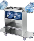 Straight Up Heavy Duty Three Tier Cleaning Cart With Two Roomy Cabinets And Smooth Rolling Wheels For Hotel Housekeeping Hustle Sturdy Painted Iron Frame Top Shelf Lid And Nifty Side Pocket Storage In Brown with water bottles on top.
