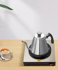 Professional Stainless Steel Coffee Warmer Plate, 80W Electric Mug Heater For Desk And Home on a wooden surface with a coffee cup.