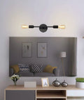 Lit Two-Light Black Bathroom Vanity Light Fixtures set above mirror in living room, modern industrial wall sconces visible.