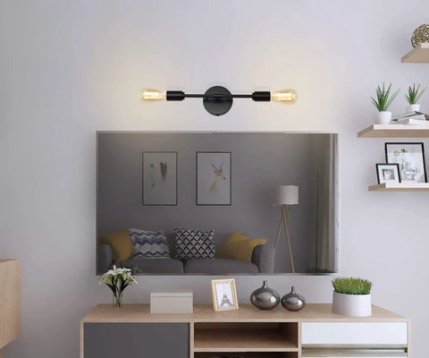 Lit Two-Light Black Bathroom Vanity Light Fixtures set above mirror in living room, modern industrial wall sconces visible.