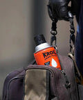 Person holding a bag with Aerokroil Penetrant Rust Penetrating Lubricant And Corrosion Inhibitor Oil For Chains Hinges And Stuck Metal Parts visible.
