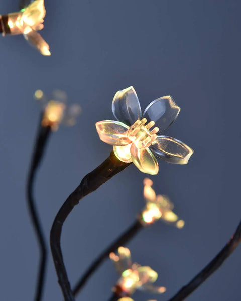 Close-up of illuminated cherry blossom on 18 Inch Cherry Blossom Bonsai Tree With 48 RGB LED Lights Remote 16 Color Changing Modes.