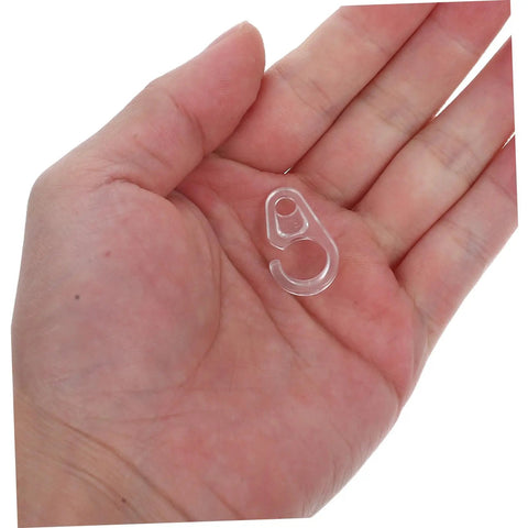 Hand holding a clear plastic hook from the 40 Pack Plastic Curtain Hooks for Shower and Window Drapery, Silent Glide and Flexible Compatibility.