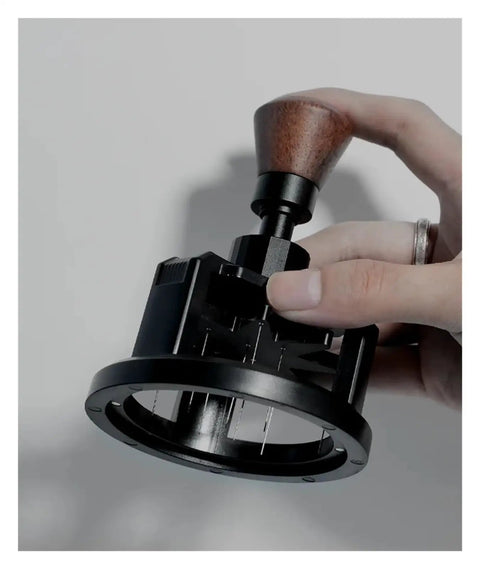 Heavy Duty 58 Millimeter Espresso Portafilter Needle Distributor With Built In Magnet held in hand for even coffee distribution.