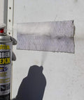 Waterproof Rubberized Sealant Spray For Fast Fixes That Seals Cracks Holes Leaks And Corrosion On Roofs And Other Surfaces With A Flexible Durable Weatherproof Rubber Coating In A 15 Ounce Bottle in use patching a wall