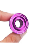 Purple CNC machined Aluminum Alloy Crank Arm Fixing Bolt And Crankset Nut For MTB Bikes, M18 size held between fingers.