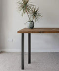 30 Inch Adjustable Round Metal Furniture Legs Set Of 4 For DIY Coffee Table And Dining Table Support Bar Counter Feet Beefy Up To 800 Lb Matte Black Finish supporting a wooden table top.