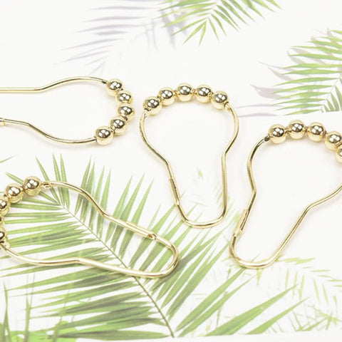 Gold Stainless Steel Shower Curtain Hooks Set Of 24 with 5 bead rollerball design on tropical background