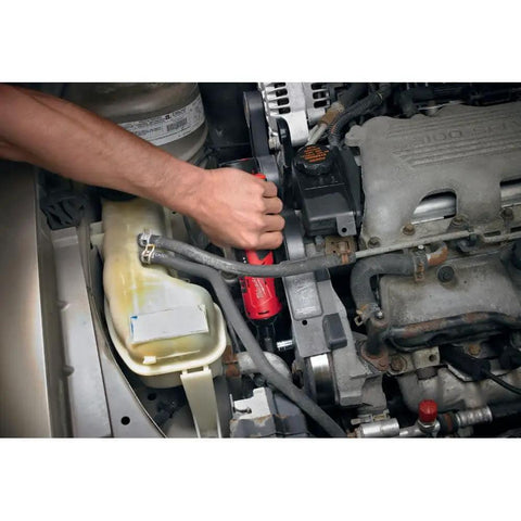Top Shelf M12 Cordless 3/8 Inch Drive Ratchet Tool With One Point Five Amp Hour Red Lithium Battery Pack in action on engine.