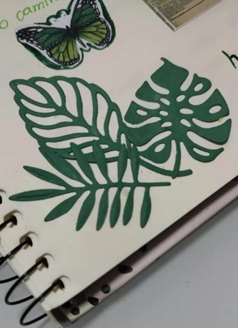 Totally Seven Piece Leaf Die Cut Set For Scrapbooking And Card Making, green leaf shapes on scrapbook page with butterfly accent