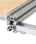 Close-up of Heavy Duty Aluminum Shelf Brackets for 2020 3030 4040 T Slot Extrusions in a shelving setup with wood surface.