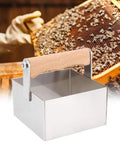 Stainless Steel Honeycomb Cutter For Beekeeping with wooden handle next to honeycomb frame in use, ideal for clean cuts.