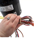 Close-up of hand holding wires of HVAC Blower Motor Three Quarter HP One Phase Three Speed 208 And 230 Volt 1075 RPM