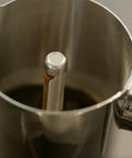Close-up of Hella Durable Stainless Steel Stovetop Espresso Maker for rich coffee brews, revealing interior design and filter.