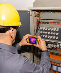 Technician using PTi120 Pocket Thermal Imager For Quick Infrared Inspections And Temperature Scans On The Go on electrical panel.