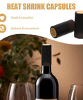 Wine Heat Shrink Capsules Set 100 Pieces With PVC Bottle Sealing Film Disposable Shrink Wrap Caps In Black For Freshness And Oxygen Lock Easy Seal Pro Grade on a wine bottle and one rolled next to glasses.