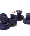 Assorted jewelry on round velvet stands for earrings and rings