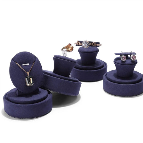 Assorted jewelry on round velvet stands for earrings and rings
