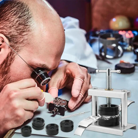 Professional watchmaker using Watch Press Tool Kit with 18 Molds and Opener Remover, Back Case Closer for repair and battery replacement.