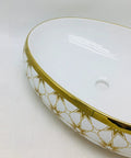 Modern Ceramic Oval Vessel Sink For A Total Bathroom Glow Up Featuring Super Sleek Gold Basin, close-up view showing details.