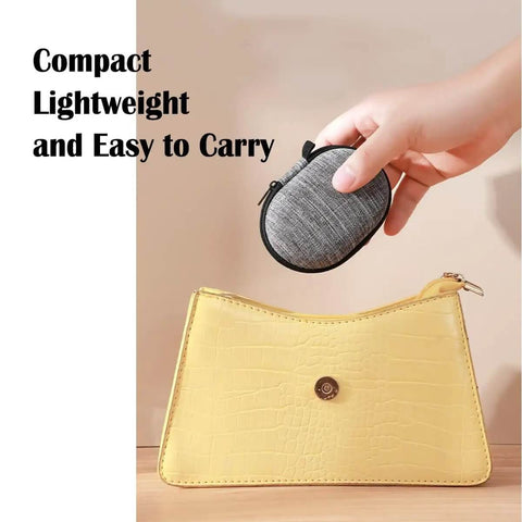 Compact Oval Tech Stash Organizer To Keep All Your Power Cords And Earbuds Straight Up Secure in hand above a yellow purse.