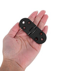 8 Piece Black Zinc Alloy Folding Table Flip Top Hinges With 180 Degree Round Edge Design held in hand, showing size and design.