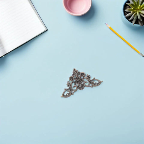 Eight Piece Jewelry Box Corner Protectors Set, Vintage Zinc Alloy Triangle Edge Guards with lace cutout design on blue background