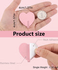 Super Sweet Pink Heart Wall Hooks 10 Pack Adhesive Hangars For Heavy Keys Towels Jackets And Bags Freakin Cute Decorative Storage Organizer For Bathroom Bedroom Or Entryway That Totally Slays Everyday Life displayed in hand showing size and adhesive backing features.