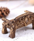 Brown resin miniature garden bench for fairy village dollhouse decor, featuring intricate detailing on legs and backrest.