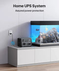 Portable Power Station With 268Wh LiFePO4 Battery Solar Generator Featuring Two 600W AC Outlets And Up To 1200W Surge next to aquarium.
